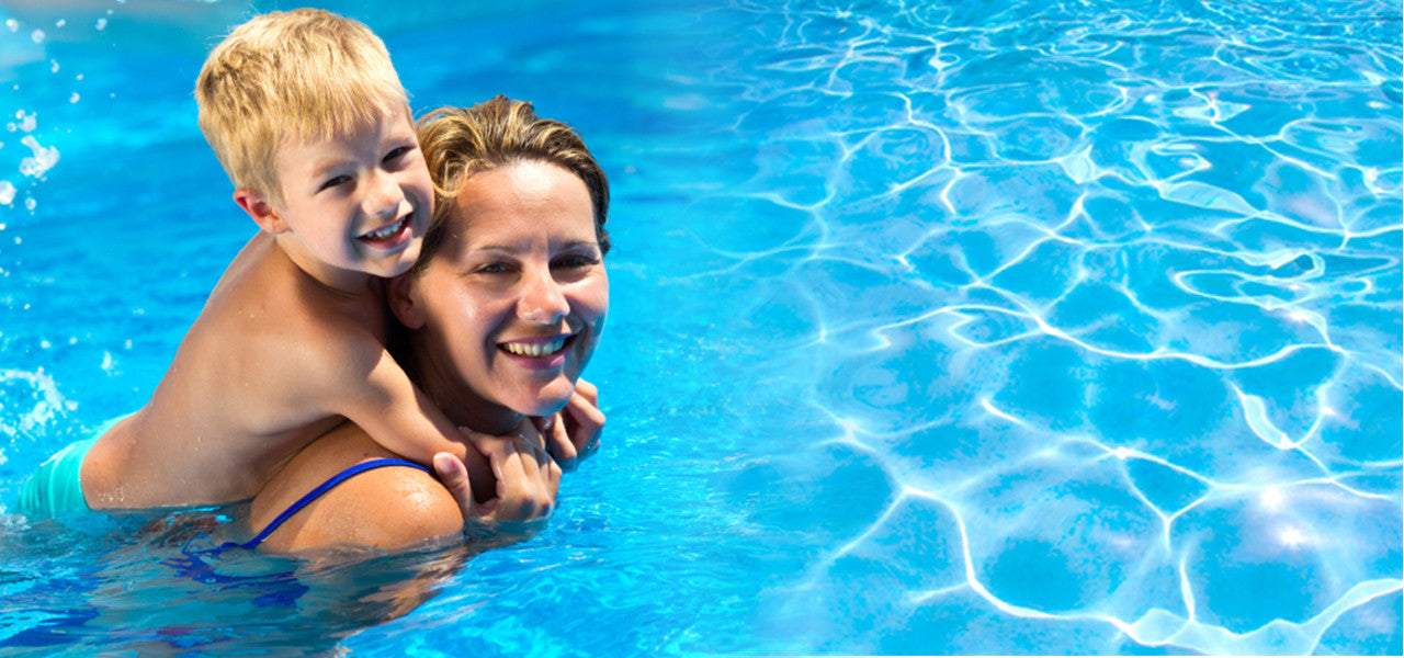 Mom with kid in the swimming pool